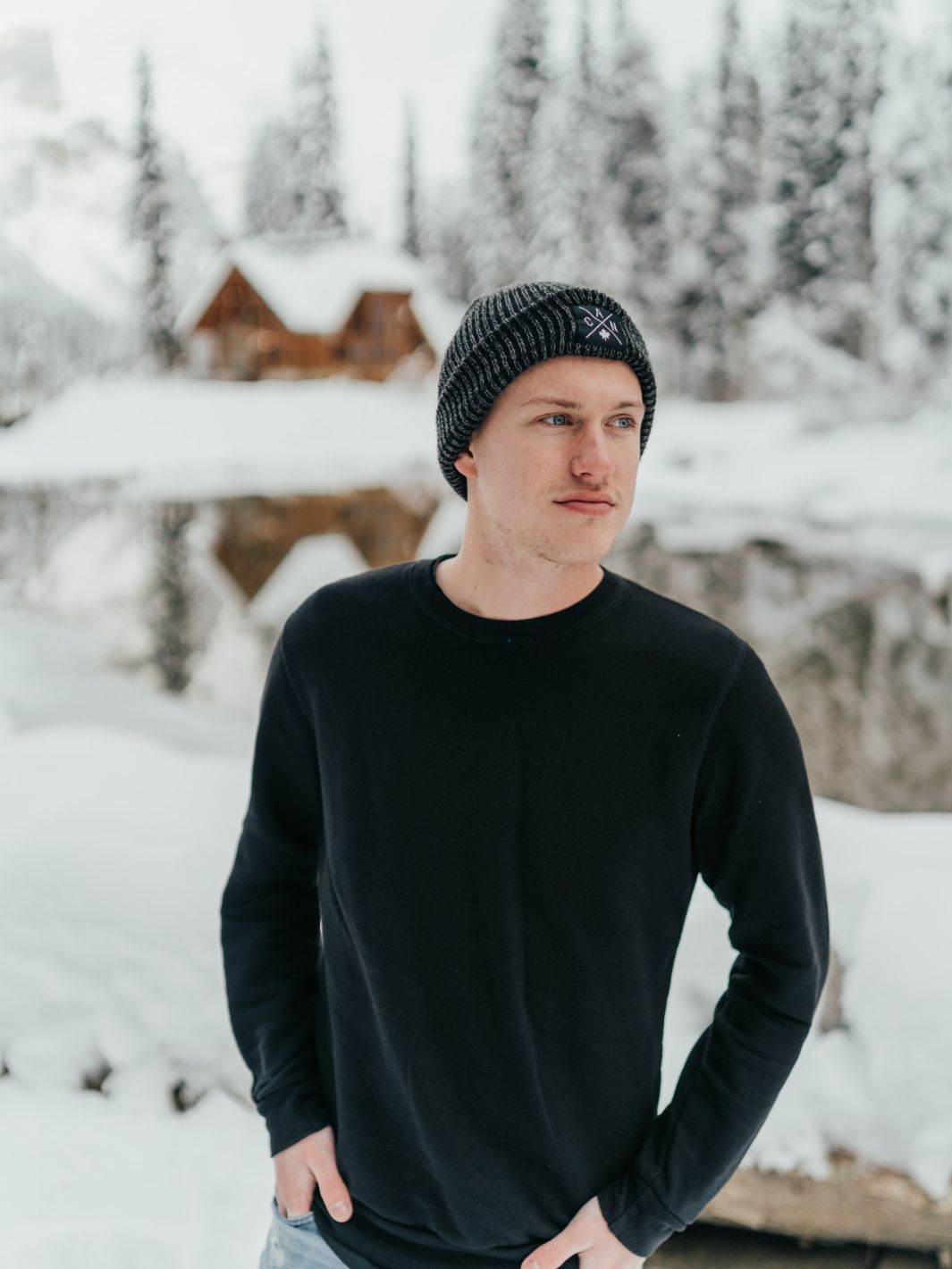 Individual wearing a blank black unisex Canadian made sweater at Emerald Lake. The sweater represents sustainable fashion, comfort, and local manufacturing.