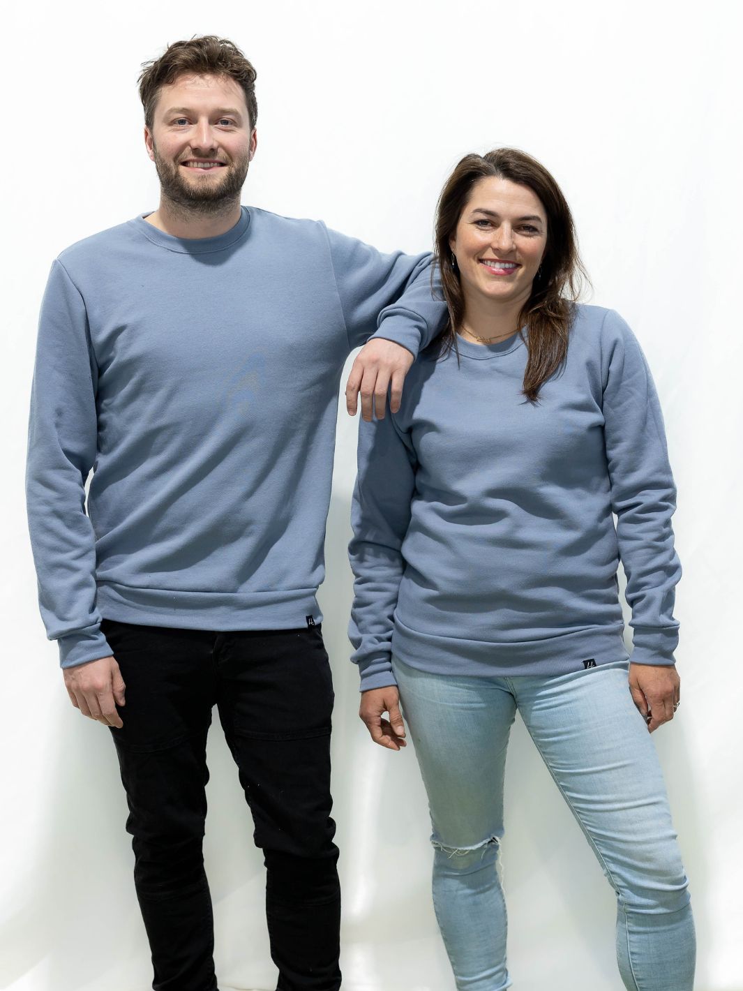 two individuals wearing Canadian made sweaters in powder blue. Made of a super soft bamboo and polyester blend.