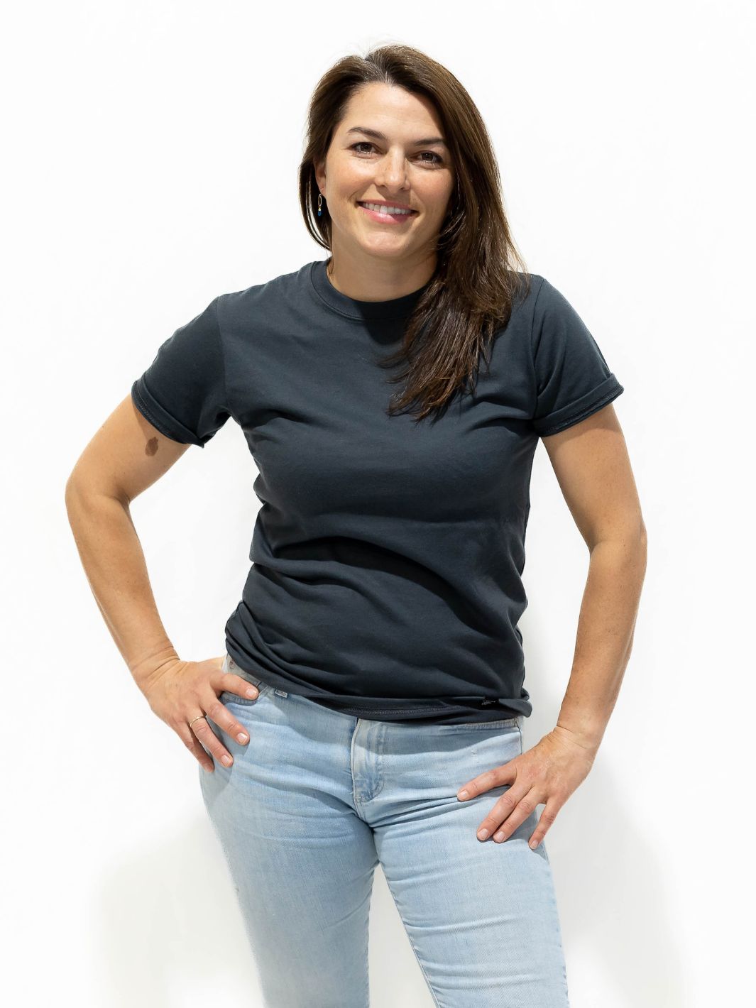 Individual wearing a Made in Canada charcoal shirt made of a premium 50/50 blend of cotton and polyester. This shirt is charcoal in colour and comes in six sizes, ranging from XS to 2XL