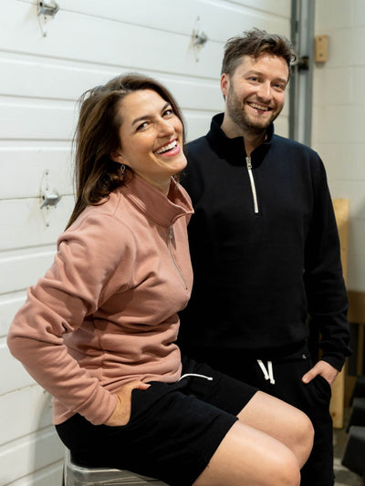 Happy individuals wearing their Made in Canada Local Laundry 3/4 zip sweaters in both black and dusty rose. These garments are paired with made in Canada Local Laundry black sweat shorts
