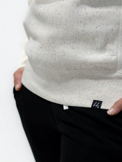 Hem detail of Local Laundry Heavyweight speckle sweater, showcasing the Local Laundry hem label. Made in Canada and constructed of ethically sourced cotton