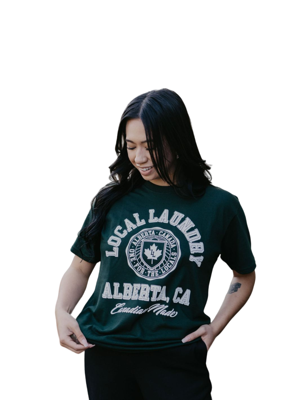 Individual sporting the Local Laundry Forest Green Varsity t-shirt, featuring a contrasting white graphics exclusive to Local Laundry. Canadian made fashion that is sustainable and ethical.
