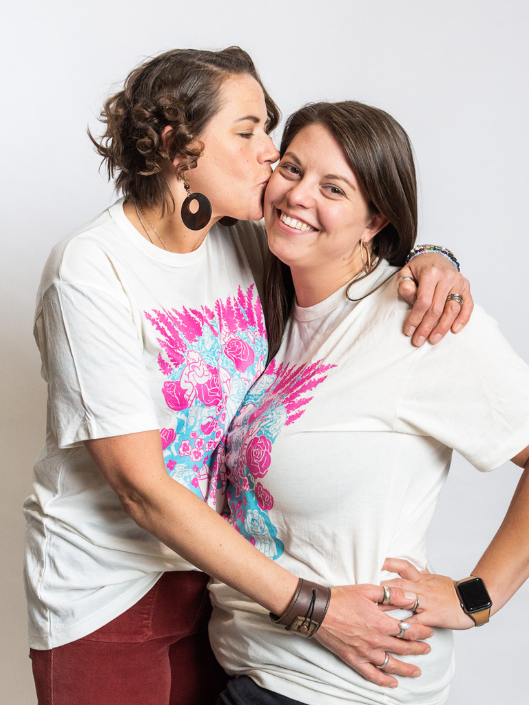 Two individuals wearing a made in Canada shirt featuring a vibrant print by a local artist. This shirt represents community and continues Local Laundries strive for sustainable, local fashion