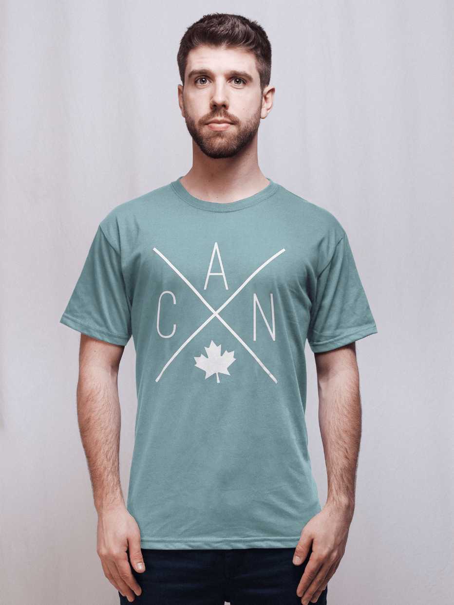 Individual wearing green unisex Made in Canada shirt, featuring the Local Laundry exclusive CAN design - this shirt represents sustainable fashion and provides local communities support