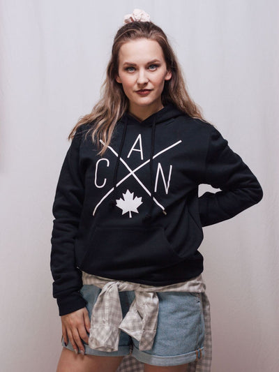 Individual wearing a sustainable Made in Canada unisex hoodie featuring Local Laundry exclusive CAN Maple Leaf design. 