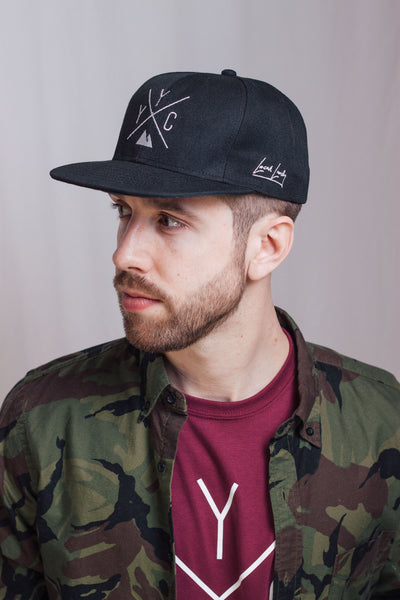 Individual wearing the Local Laundry YYC Snapback hat, paired with the maroon local laundry t-shirt