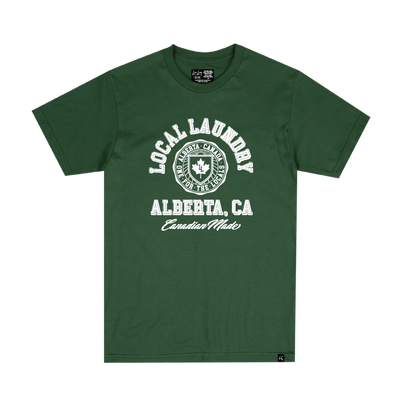 The Varsity t-shirt in forest green, by Local Laundry. Featuring a white graphic on the front with "Local Laundry" in college script and "Alberta, CA" on the bottom portion of the graphic. This tshirt is sustainably made in Canada, utilizing a premium blend of cotton and polyester