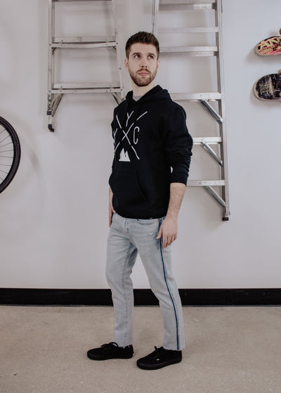 Individual showcasing the Local Laundry YYC hoodie, featuring the exclusive Local Laundry YYC graphic. Sustainably made in Canada.