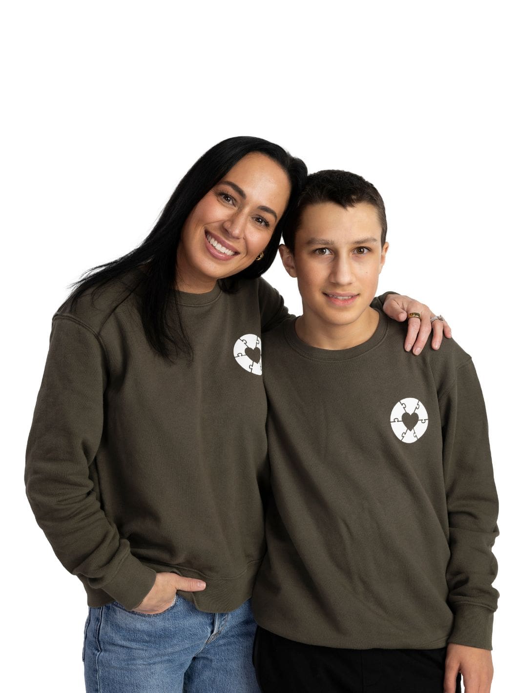 Individuals wearing a olive green sweater that features a white heart on the left chest, representing the Ryder's Foundation for Autism, this exclusive Local Laundry piece is sustainably made in Canada and aims to support local communities and raise awareness for those diagnosed with Autism.