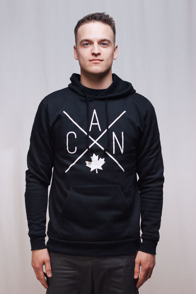 Individual wearing Made in Canada black unisex hoodie featuring Local Laundry exclusive CAN Maple Leaf design. 