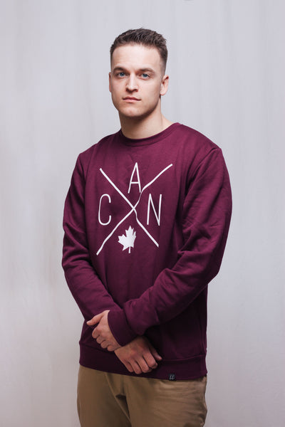 Individual wearing Made in Canada maroon sweater, featuring a Local Laundry exclusive eye catching CAN design featuring a maple leaf. 