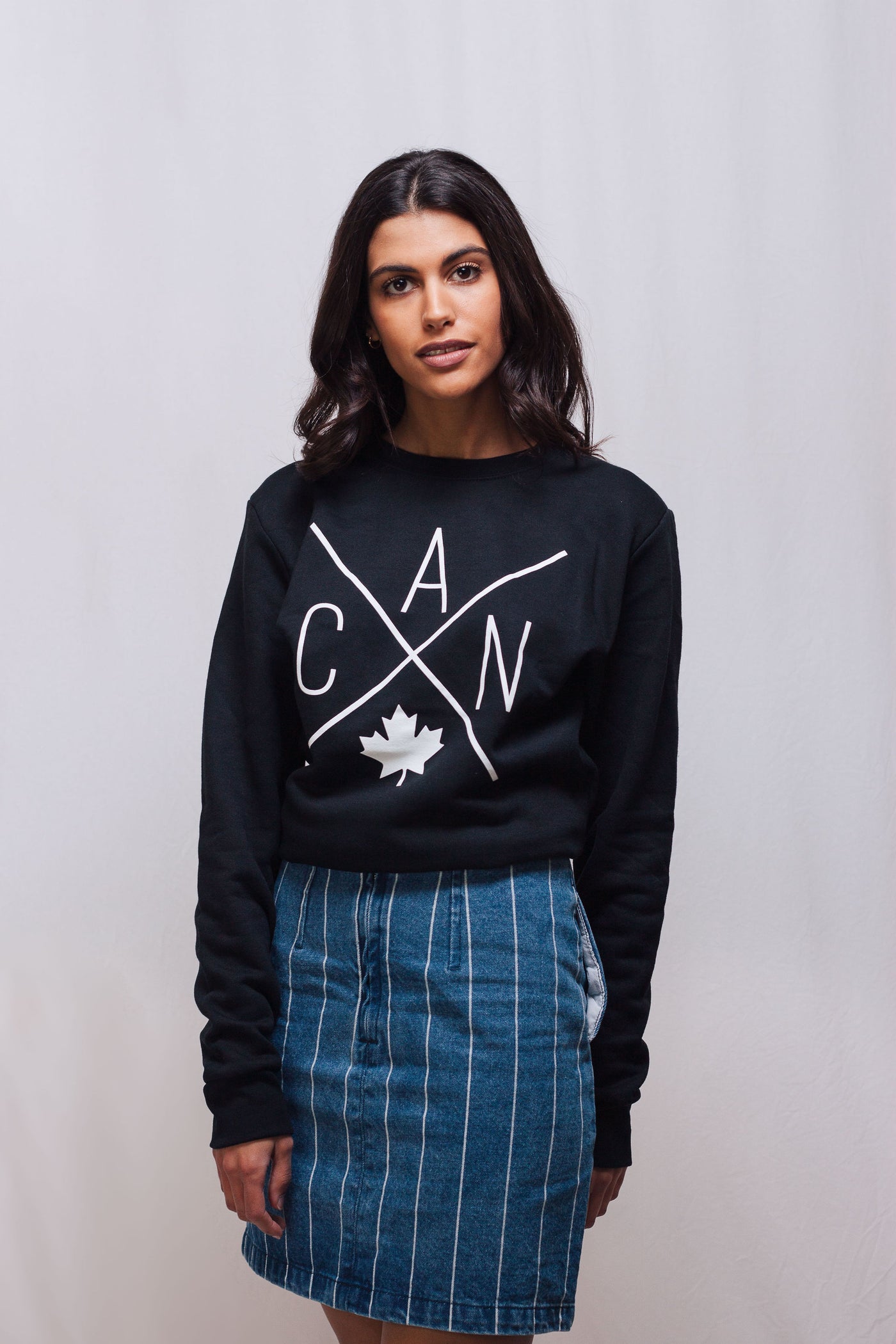Individual wearing Made in Canada sweater, featuring a Local Laundry exclusive eye catching CAN design featuring a maple leaf. 